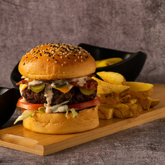 Brioche Cheeseburger with Pickles, Bacon, and Caramelized Onions with French Fries