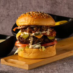 Brioche Cheeseburger with Pickles, Bacon, and Caramelized Onions