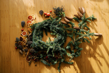 Blank for a Christmas wreath lies on a wooden floor