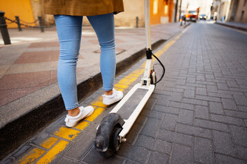  Close up view of woman riding e scooter