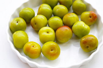 Fresh green plum on white background