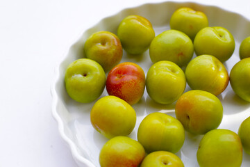 Fresh green plum on white background