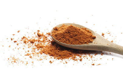 Mexican taco seasoning, pile in wooden spoon isolated on white, side view
