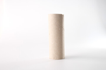 Cylindrical empty cardboard tube on white surface, showcasing a repurposed item for DIY crafts. Perfect for craft stores, recycling campaigns, and educational projects about sustainability