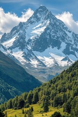 Fototapeta premium Tall mountain peak rises above green trees. Snow covers top. Blue sky and white clouds above mountain. Forest on hills. Sunny day.