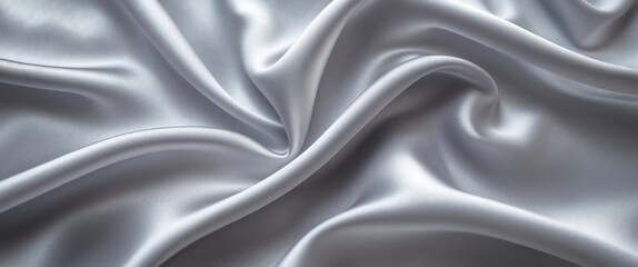 Obraz premium Blurred satin texture in gray background. Close-up light gray satin fabric surface. Concept of luxury, fabric curve, gradient, fashion, fibers, and textiles. Wavy satin creating a textured background.
