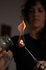masseur applying fire in alternative treatment vessels