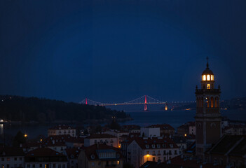 Illuminated bridge and bell tower at night cityscape