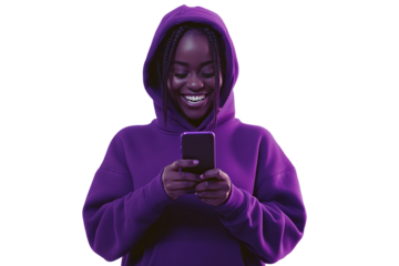 a woman holding her phone smiling and looking excited wearing a dark bluish purple hoodie isolated on a white background