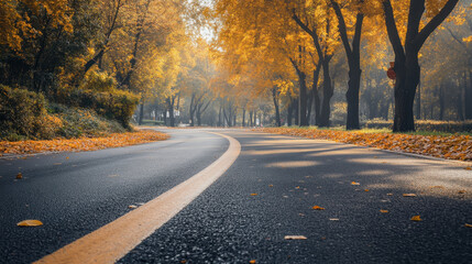 Fototapeta premium Serene Autumn Road Surrounded by Vibrant Yellow and Orange Foliage