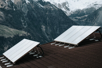 Solar panels on the roof of a house in the mountains. .Green energy concept.Solar Panels on Rooftop...