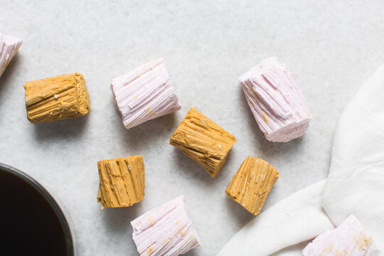 Overhead view of Nigerian Balewa candy, top view of hausa alewa candy on a white background, pulled hard sugar candy on a white countertop