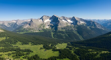 Fototapeta premium Scenic Rocky Mountain Range Landscape with Lush Forest, Meadows, and Clear Blue Sky