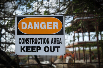 danger keep out sign at a construction site. do not enter signage messaging caution safety...