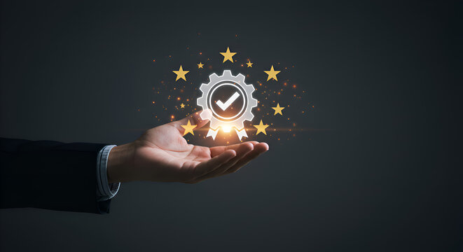 hand presenting a luminous gear and checkmark icon, embodying certification, excellence, and high standards amidst golden sparkles."
