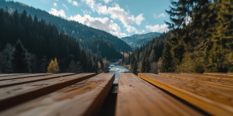 Fototapeta premium A wooden bench with a view of a river and mountains