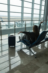 happy young latina girl resting and waiting for her plane to go on vacation