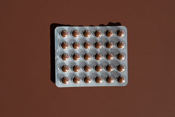 Pills Blister Pack On Brown Background.