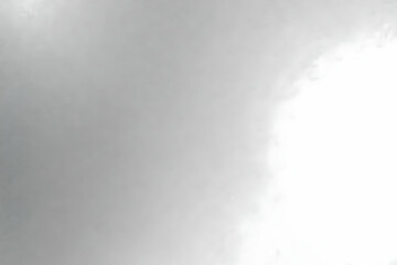 Abstract grayscale cloud formation background image showing a blend of dark and light shades, creating a hazy, atmospheric effect perfect for design projects.