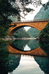 A bridge spanning a body of water, framed by a mountain in the distance.
