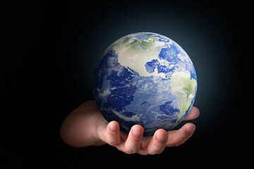 Planet in our hands. Man holding Earth model on black background, closeup