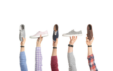 Men holding different shoes in hands on white background, closeup
