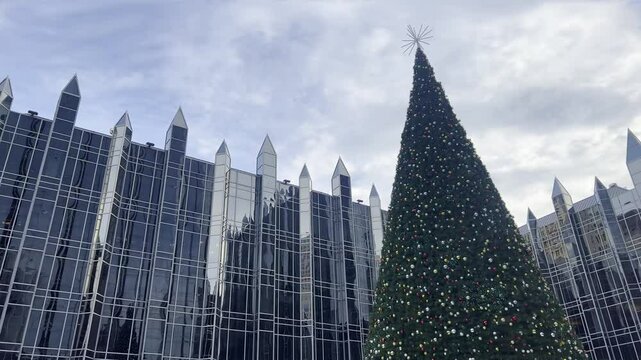 The Christmas tree in Market Square, Pittsburgh, shines brightly against the winter sky, bringing festive charm to the heart of the city
