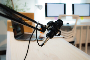 Professional condenser microphone occupying a desk, poised for podcast recording, voiceovers, and...