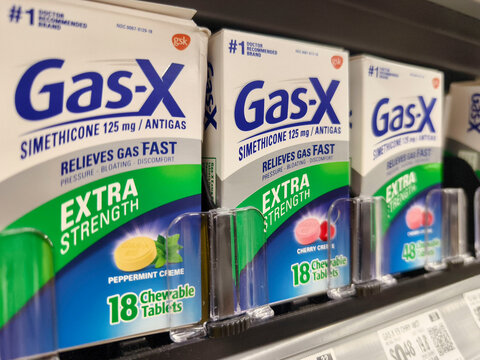 Shelf display of Gas-X chewable tablets in various flavors at a supermarket