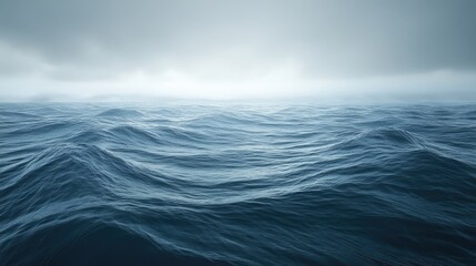 A calm ocean is shown with water and a cloudy sky