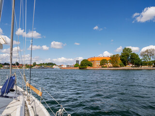 Sailboat on Alssund passing Sonderborg Castle Museum in Sonderborg, Als Island, Southern Denmark
