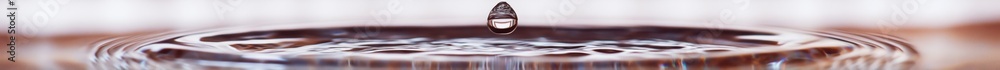 Poster close up macro shot of a crystal clear water drop forming from a water filter with soft reflections 
