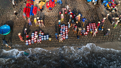 Dawn at Phuoc The fishing port, Binh Thuan, when the fishing boats return to the wharf, the fishing...