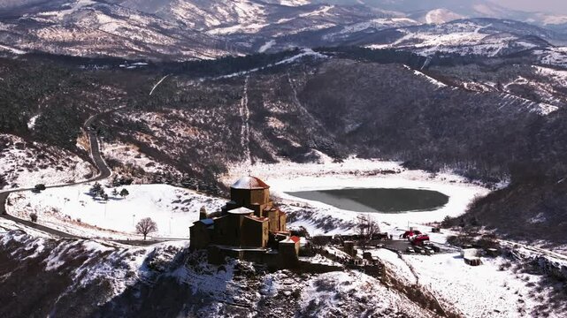 Aerial footage of the Jvari monastery, VI century, UNESCO Heritage. Drone flight over Jvari Monastery near Mtskheta, Georgia, on a sunny day, with beautiful views during daytime.