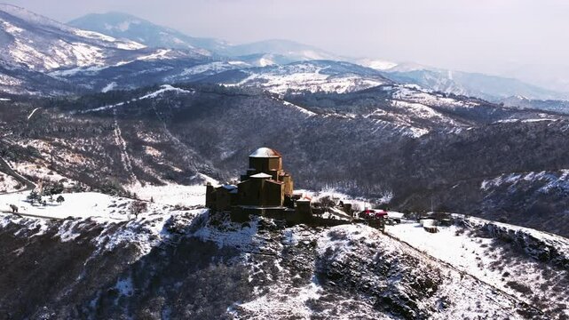 Aerial footage of the Jvari monastery, VI century, UNESCO Heritage. Drone flight over Jvari Monastery near Mtskheta, Georgia, on a sunny day, with beautiful views during daytime.