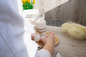 Unrecognizable woman creating Easter holiday decoration from sustainable materials egg shell. Diy...