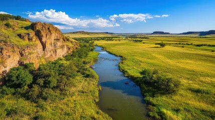 Serene River Flowing Through Lush Green Landscape Under Blue Sky