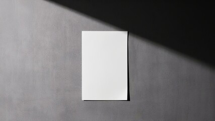 pure white a4 paper stuck on a grey wall with soft shadows,wall,gray