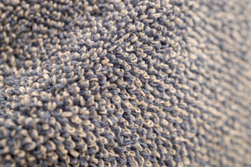 Macro texture background of a light blue and white cotton towel surface with looped yarn
