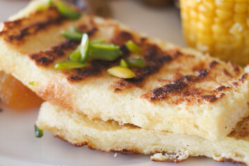 Grilled Bread Slices Garnished with Herbs and Served on a Decorative Plate
