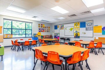 Bright and colorful classroom with orange chairs, decorated walls, and natural light creating an inviting and cheerful learning environment.