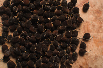 Overhead view of velvet tamarind, top view of velvet tamarind bunch on wood background