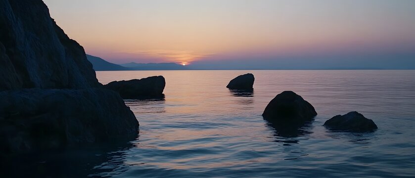 Breathtaking sunset view over a calm and serene ocean with rugged rocky cliffs and coastline silhouetted against the vibrant colors of the evening sky  A peaceful and dramatic natural landscape scene - Powered by Adobe