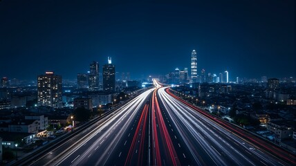 Fototapeta premium Aerial view of busy highway at night with city lights.