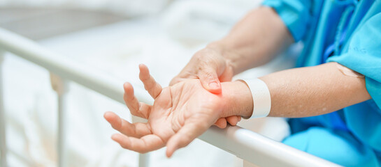 Elderly Patient Woman having wrist pain in hospital, muscle ache due to Carpal Tunnel Syndrome, De Quervain s tenosynovitis, rheumatoid, arthritis, gout, Parkinson disease and ergonomic healthcare