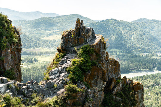natural landmark of Altai rock fucking finger. Top view of valley of Katun River and forest on banks of mountain river. Devil's finger-rock in Altai