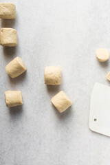 Overhead view of steamed bun dough on a white countertop, top view of mantou dough, process of making steamed milk buns	