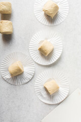 Overhead view of steamed bun dough on a white countertop, top view of mantou dough, process of making steamed milk buns	