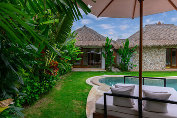 Balenese Pool Villa in Seminyak on the beautiful island of Bali colourful skies lush green tress Bali Indonesia