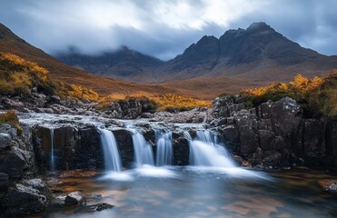 Obraz premium Tranquil Mountain Stream with Cascading Waterfalls under Dramatic Sky in Scottish Highlands, Captured in Autumn with Rich Colors and Majestic Peaks